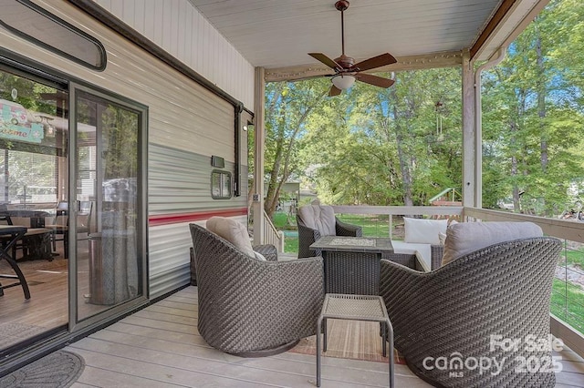 wooden deck with a ceiling fan and an outdoor living space