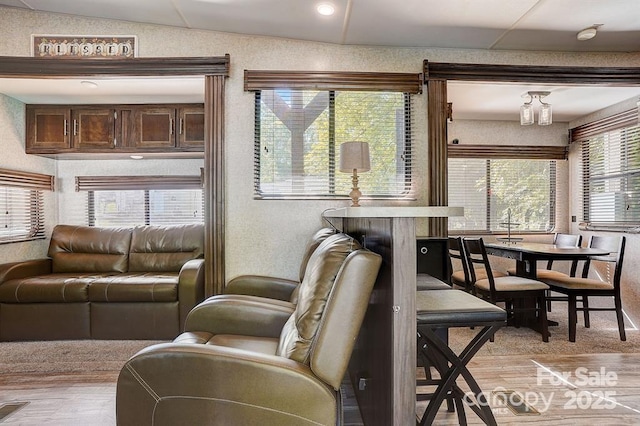 living room featuring vaulted ceiling and light wood-style floors