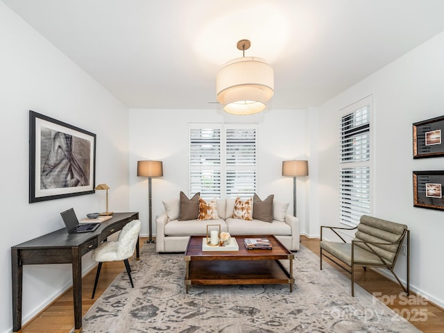 living room with baseboards and wood finished floors