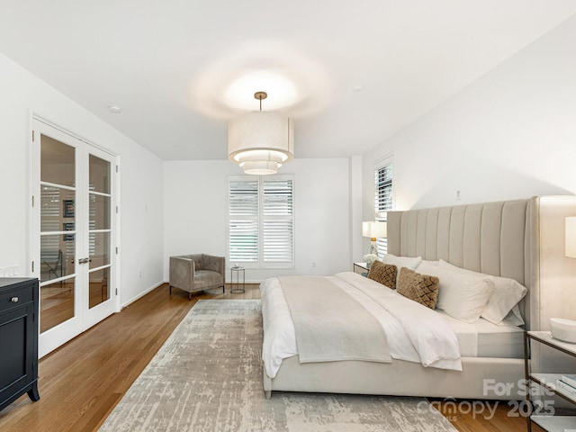 bedroom featuring french doors and wood finished floors