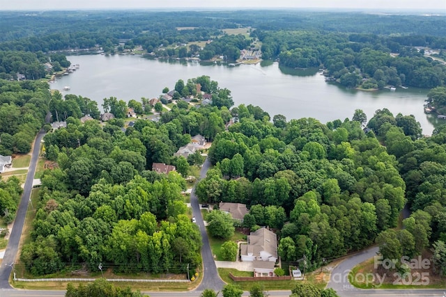 aerial view featuring a water view and a wooded view