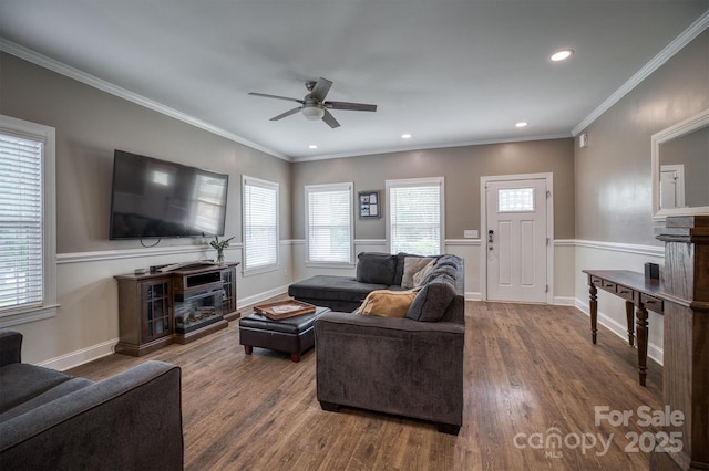 living area with a healthy amount of sunlight, a fireplace, and wood finished floors