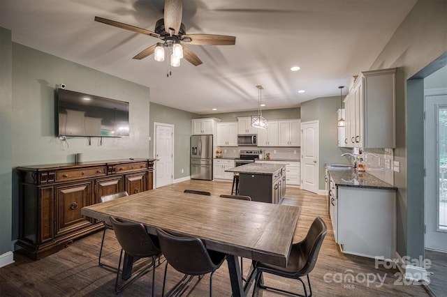 dining area with dark wood-style floors, ceiling fan, baseboards, and recessed lighting