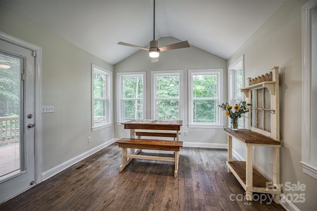 dining space with vaulted ceiling, dark wood-type flooring, visible vents, and baseboards