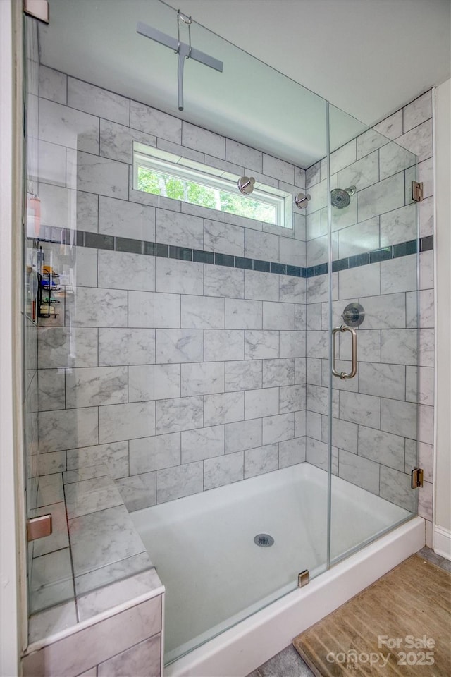 bathroom with a stall shower and plenty of natural light