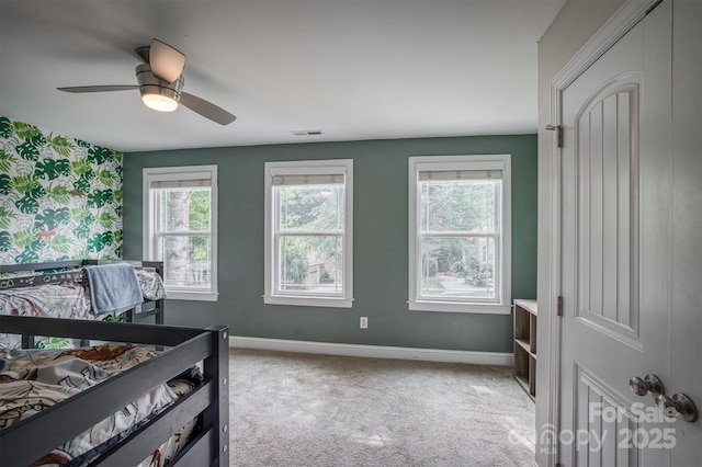 bedroom featuring visible vents, ceiling fan, light carpet, and baseboards