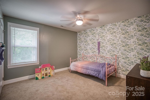 bedroom with wallpapered walls, carpet, baseboards, and a ceiling fan