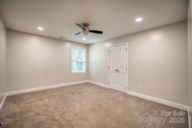 carpeted spare room featuring ceiling fan, recessed lighting, visible vents, and baseboards