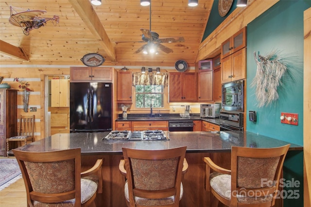 kitchen with lofted ceiling with beams, a sink, wood ceiling, black appliances, and glass insert cabinets