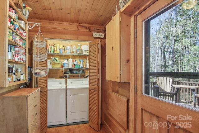 washroom with laundry area, wooden ceiling, light wood-style flooring, and washing machine and clothes dryer