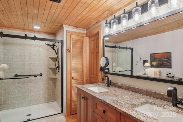 bathroom with double vanity, a stall shower, wood ceiling, and a sink