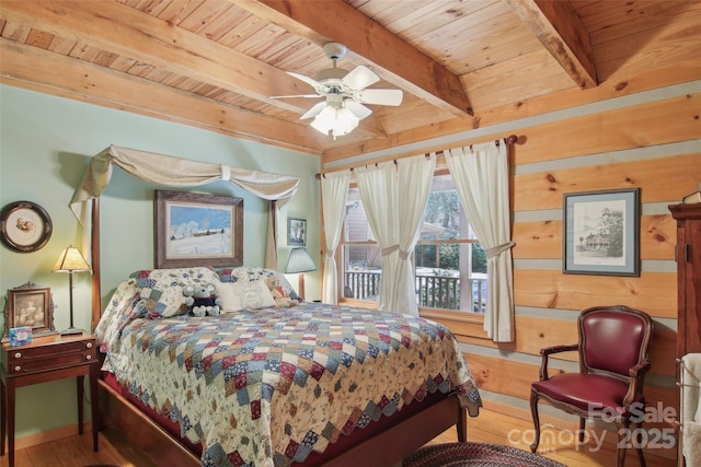 bedroom with wooden ceiling, wood finished floors, beam ceiling, and wooden walls