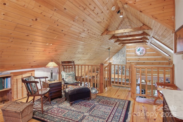 living area with lofted ceiling with beams, hardwood / wood-style flooring, an upstairs landing, and wood ceiling