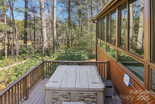 wooden deck featuring a sunroom and outdoor dining space