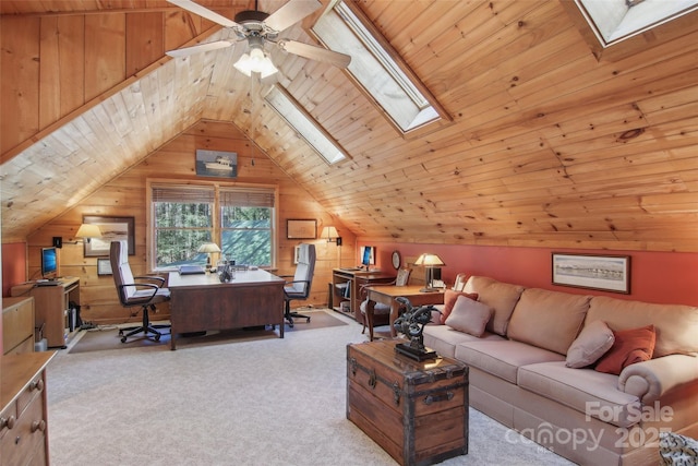 carpeted office space with lofted ceiling with skylight, wooden ceiling, wooden walls, and a ceiling fan