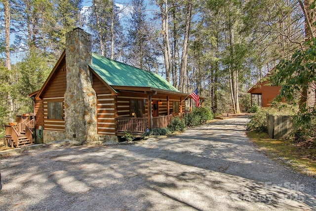 380 Cedar Ln, Brevard, NC 28712 - view of side of property featuring a porch, gravel driveway, metal roof, and a chimney
