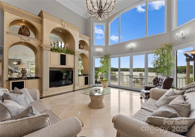 living area featuring light tile patterned flooring, a notable chandelier, a high end fireplace, french doors, and ornamental molding