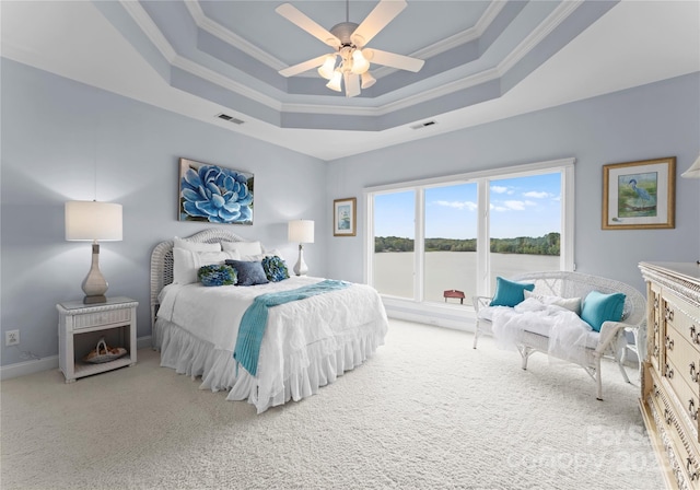 bedroom featuring carpet floors, a raised ceiling, and visible vents