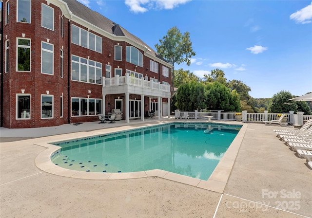 view of swimming pool featuring a fenced in pool, a patio area, and fence