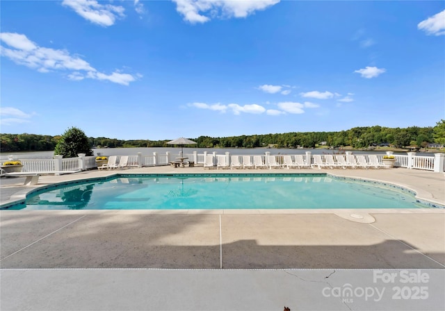 view of swimming pool with a patio area, fence, and a fenced in pool