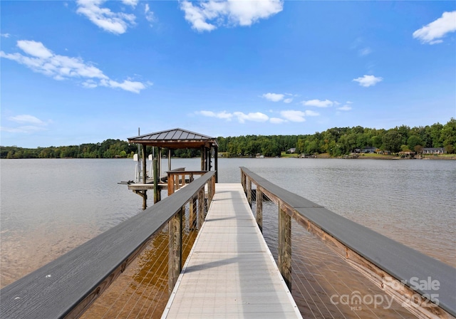 view of dock featuring a water view and a view of trees