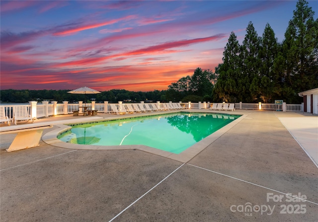 view of swimming pool with a patio area, fence, and a fenced in pool