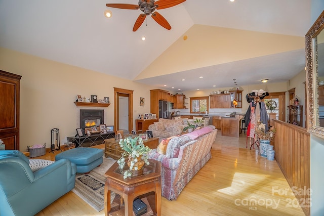 living area featuring ceiling fan, high vaulted ceiling, light wood finished floors, and recessed lighting