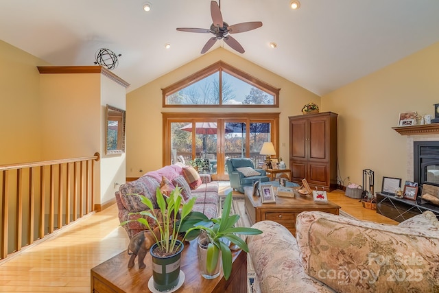 living room featuring recessed lighting, wood finished floors, a ceiling fan, baseboards, and vaulted ceiling