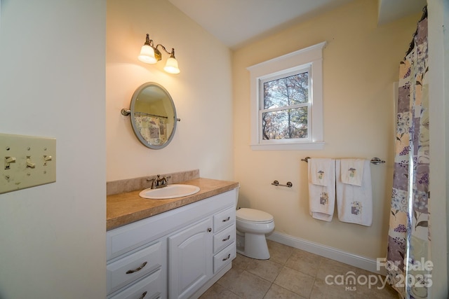 full bathroom with tile patterned flooring, baseboards, vanity, and toilet