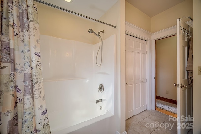 bathroom with shower / bath combination with curtain and tile patterned floors