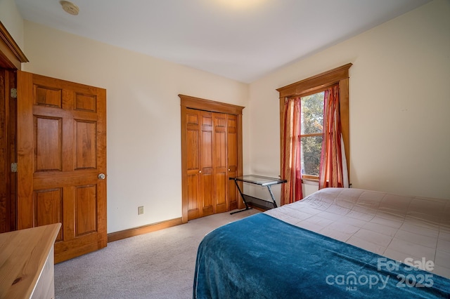 bedroom featuring light carpet and baseboards