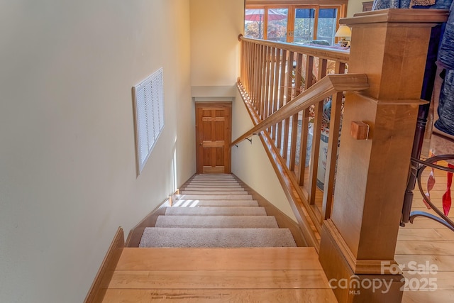 staircase featuring a high ceiling