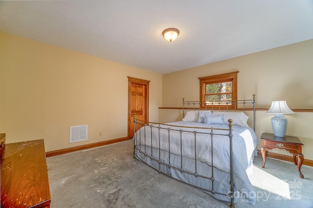 bedroom featuring baseboards, concrete floors, and visible vents