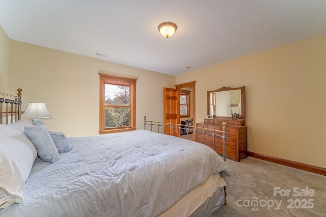 bedroom with light carpet, baseboards, and visible vents