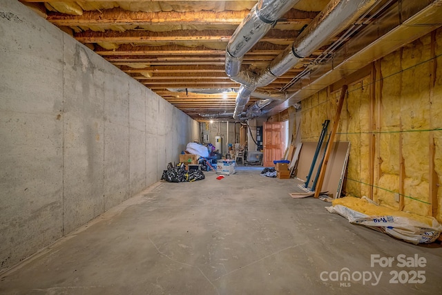 unfinished basement featuring gas water heater