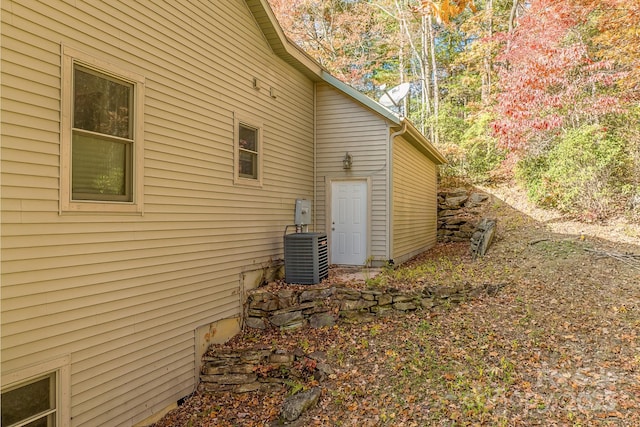 view of side of home with central air condition unit