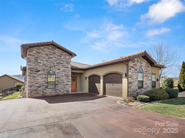 view of front of house featuring stucco siding, an attached garage, stone siding, driveway, and a tiled roof