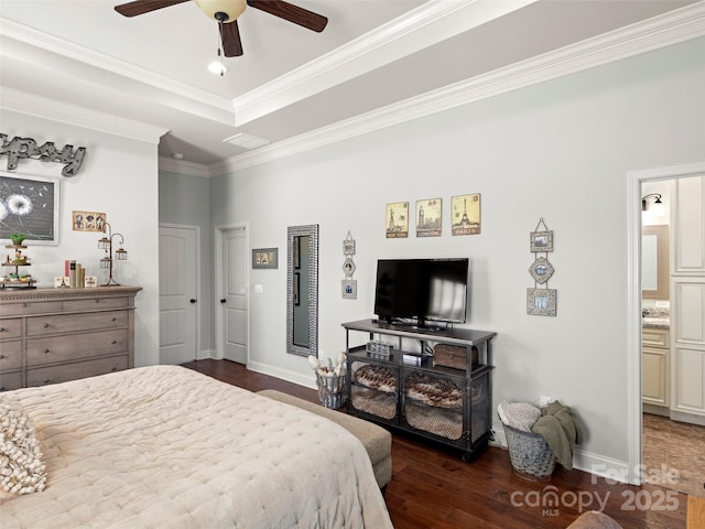 bedroom featuring baseboards, a tray ceiling, wood finished floors, and ornamental molding