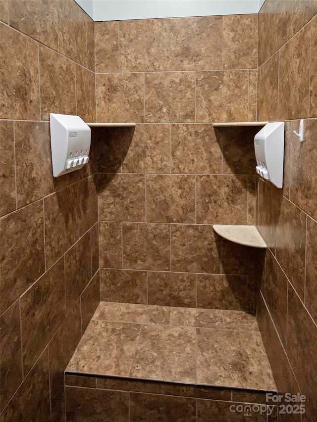 bathroom with tiled shower