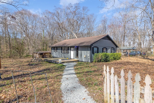 view of front of home with driveway and fence