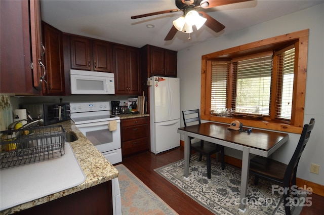 kitchen featuring light countertops, white appliances, dark wood-style flooring, and a ceiling fan