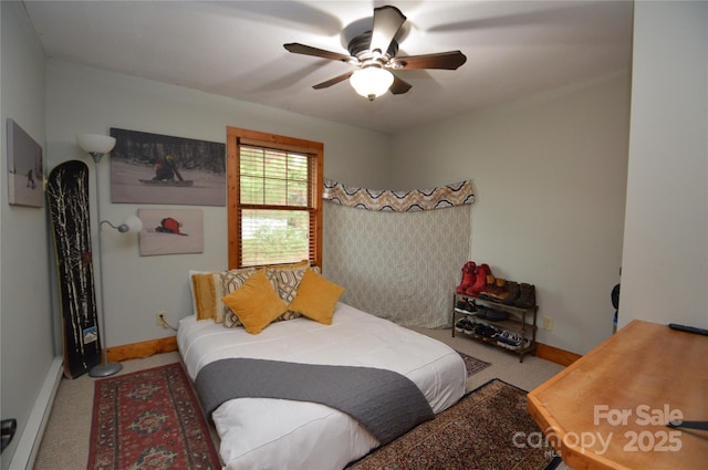 bedroom with a ceiling fan, baseboards, and carpet flooring