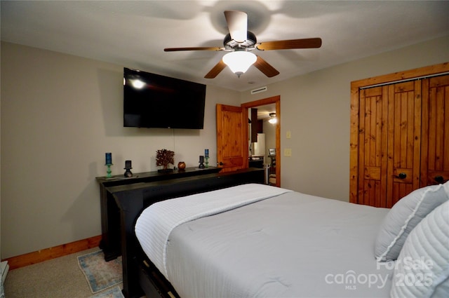 bedroom featuring ceiling fan, a closet, and baseboards