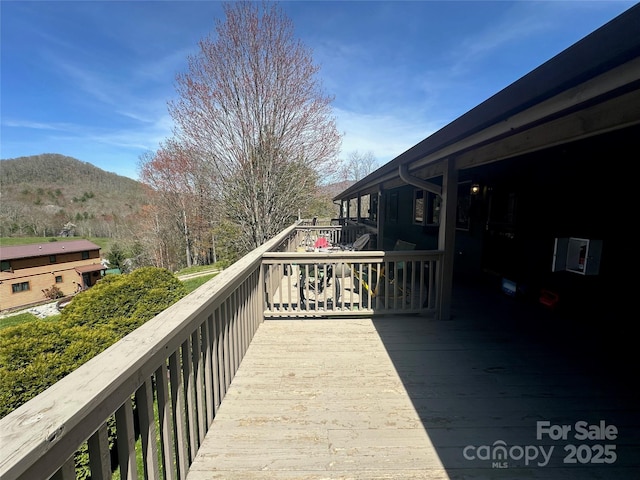 wooden deck with a mountain view