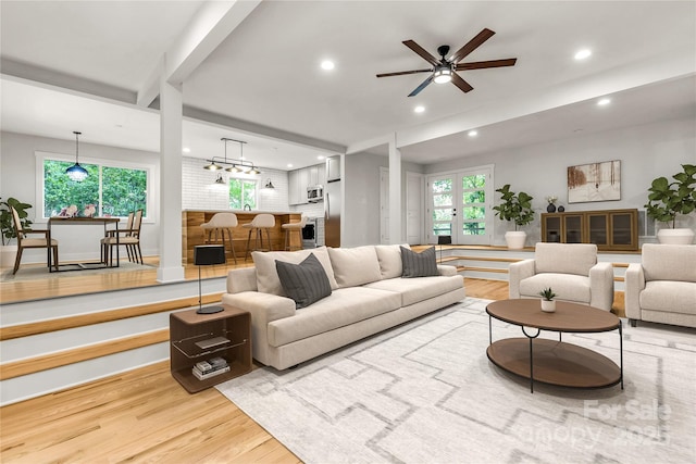 living area with a ceiling fan, recessed lighting, a healthy amount of sunlight, and wood finished floors