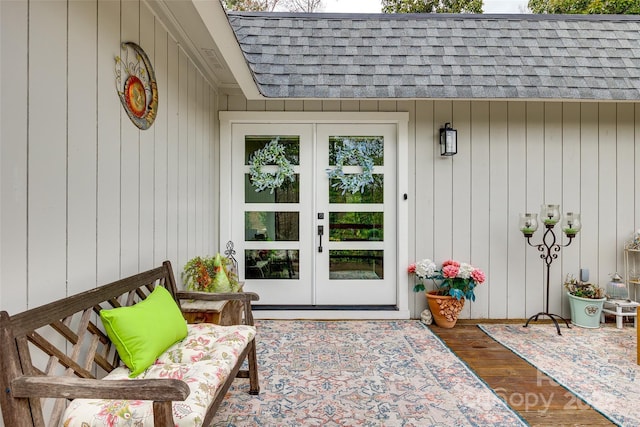 property entrance with french doors and roof with shingles