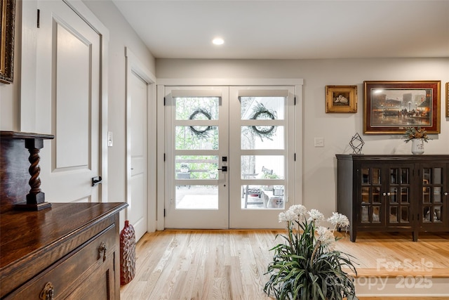 entryway with recessed lighting, light wood-style flooring, and french doors