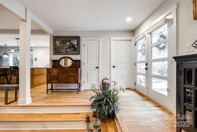 interior space with light wood finished floors, recessed lighting, and french doors