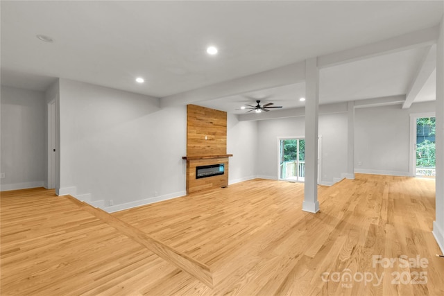 unfurnished living room with a large fireplace, baseboards, a ceiling fan, light wood-style floors, and recessed lighting