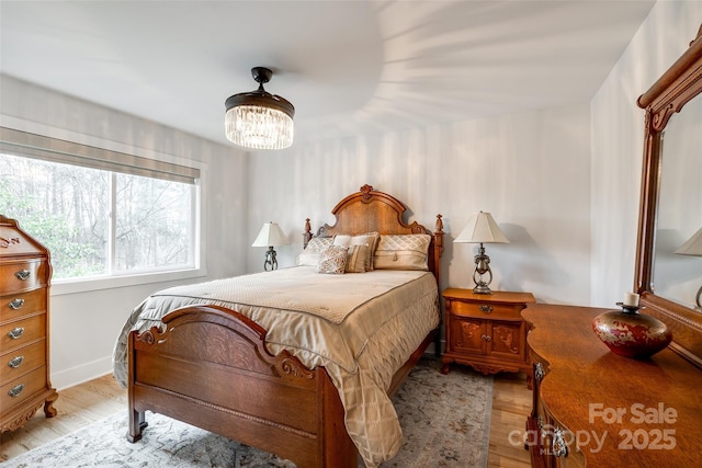 bedroom featuring light wood-type flooring and baseboards